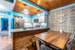 dining area and kitchen, stainless steel appliances, beach decor